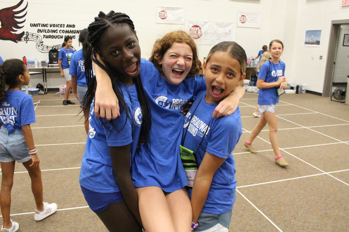 Three Broadway Bound campers laughing together