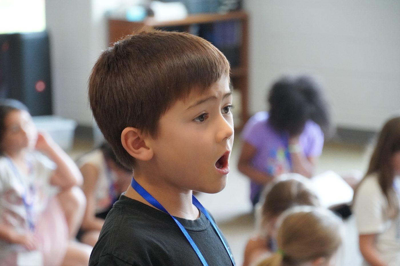 Young camper singing during a vocal session